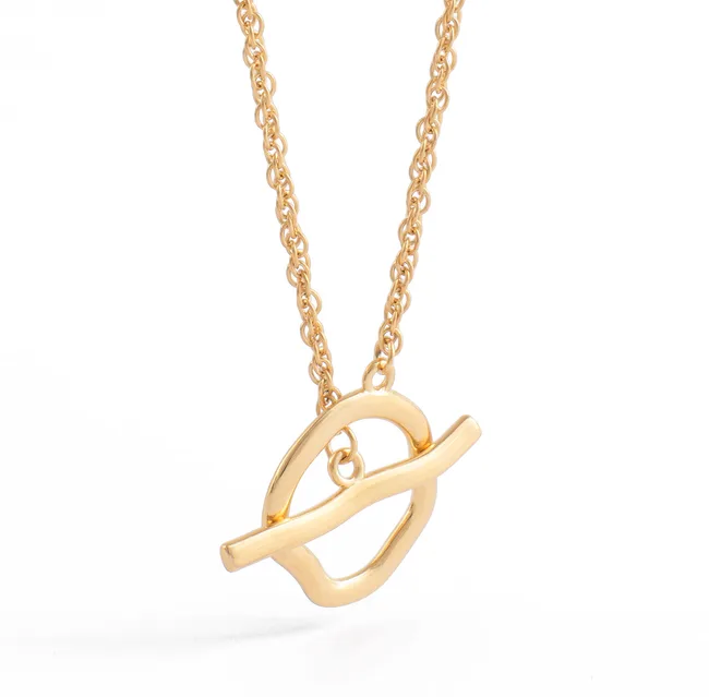 Gold necklace with an abstract pendant featuring interlocking shapes on a fine chain.