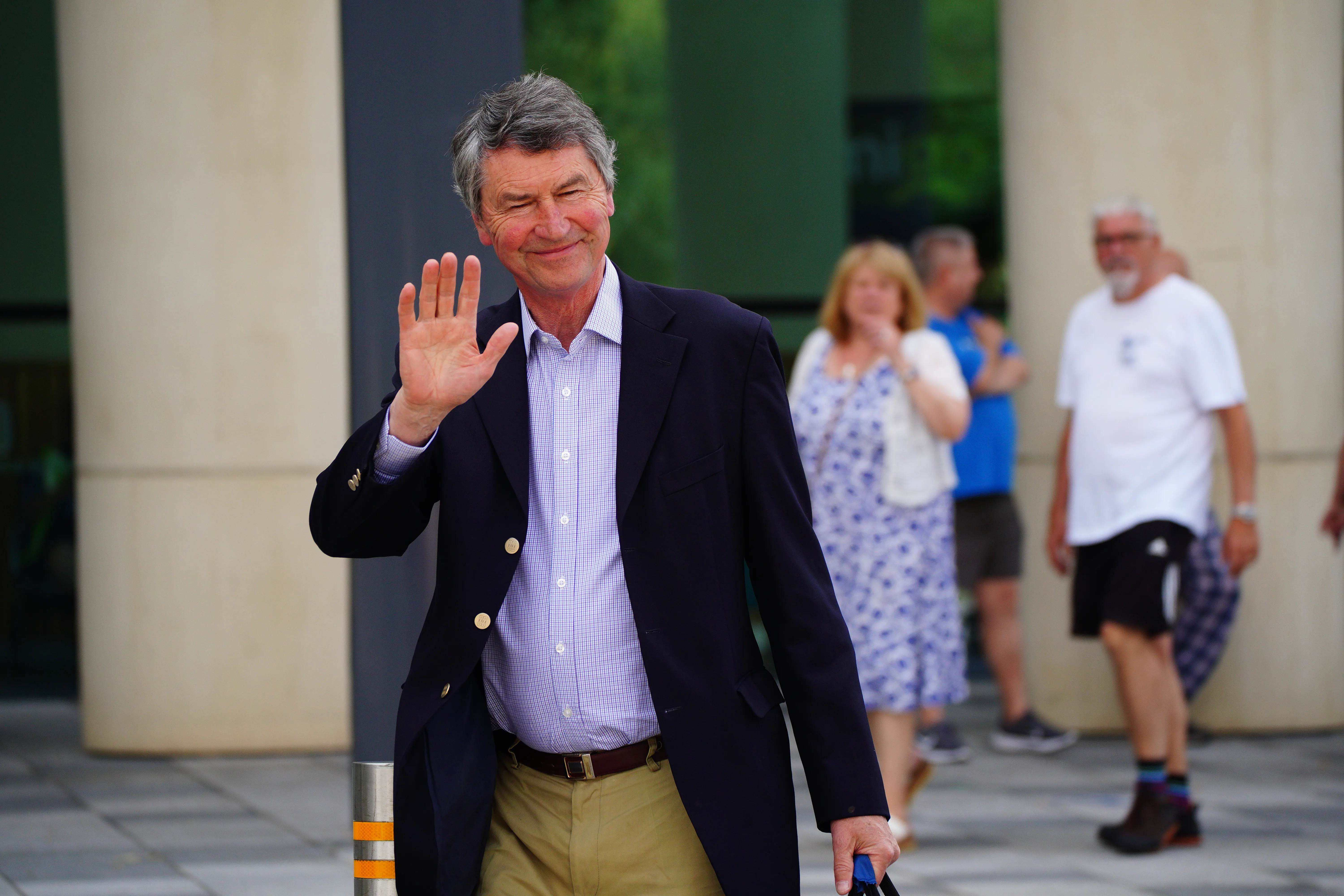Sir Timothy Laurence waves to well-wishers as he visits his wife, Princess Anne, in hospital.