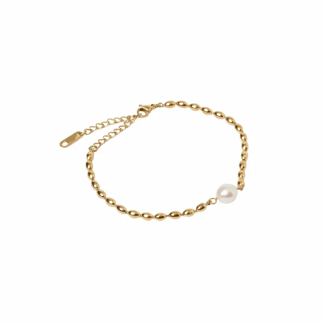 A gold link bracelet with a single pearl accent on a white background.