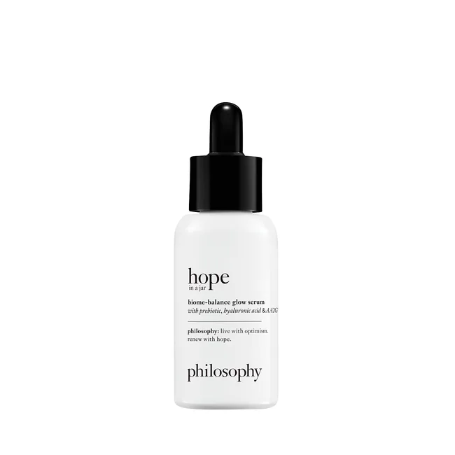 White bottle of Philosophy "Hope in a Jar" glow serum with a black dropper cap, text detailing contents and brand.
