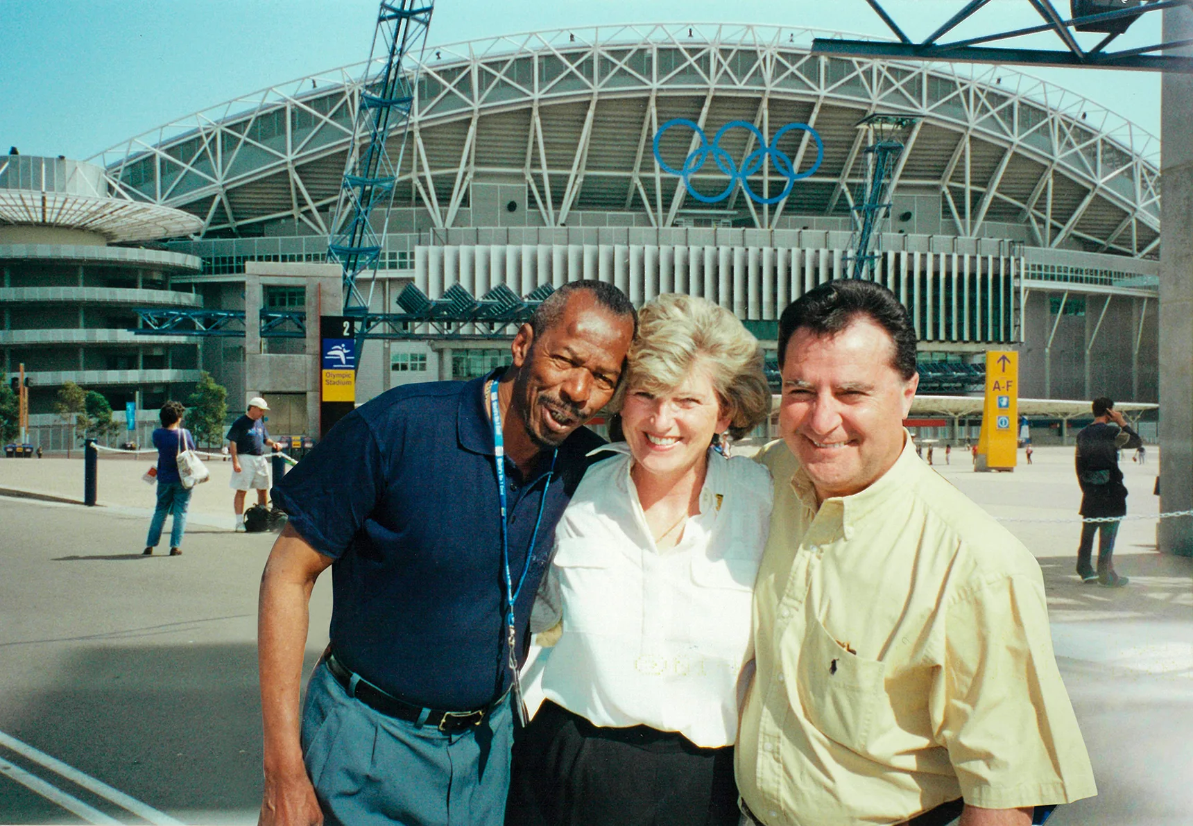 Olympic Volunteer Rosemary with her husband and an athlete.