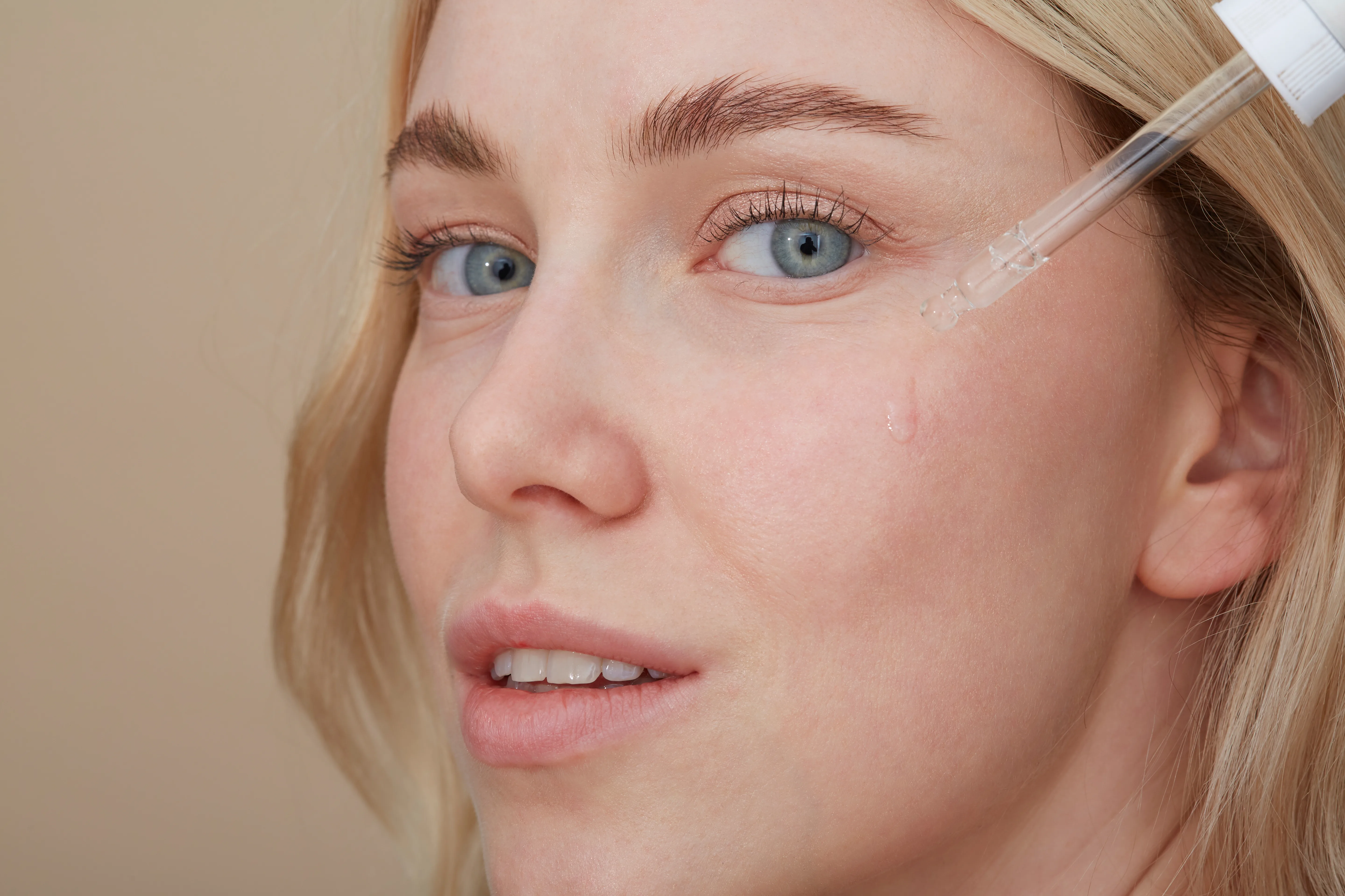 Woman using probiotics for skin.