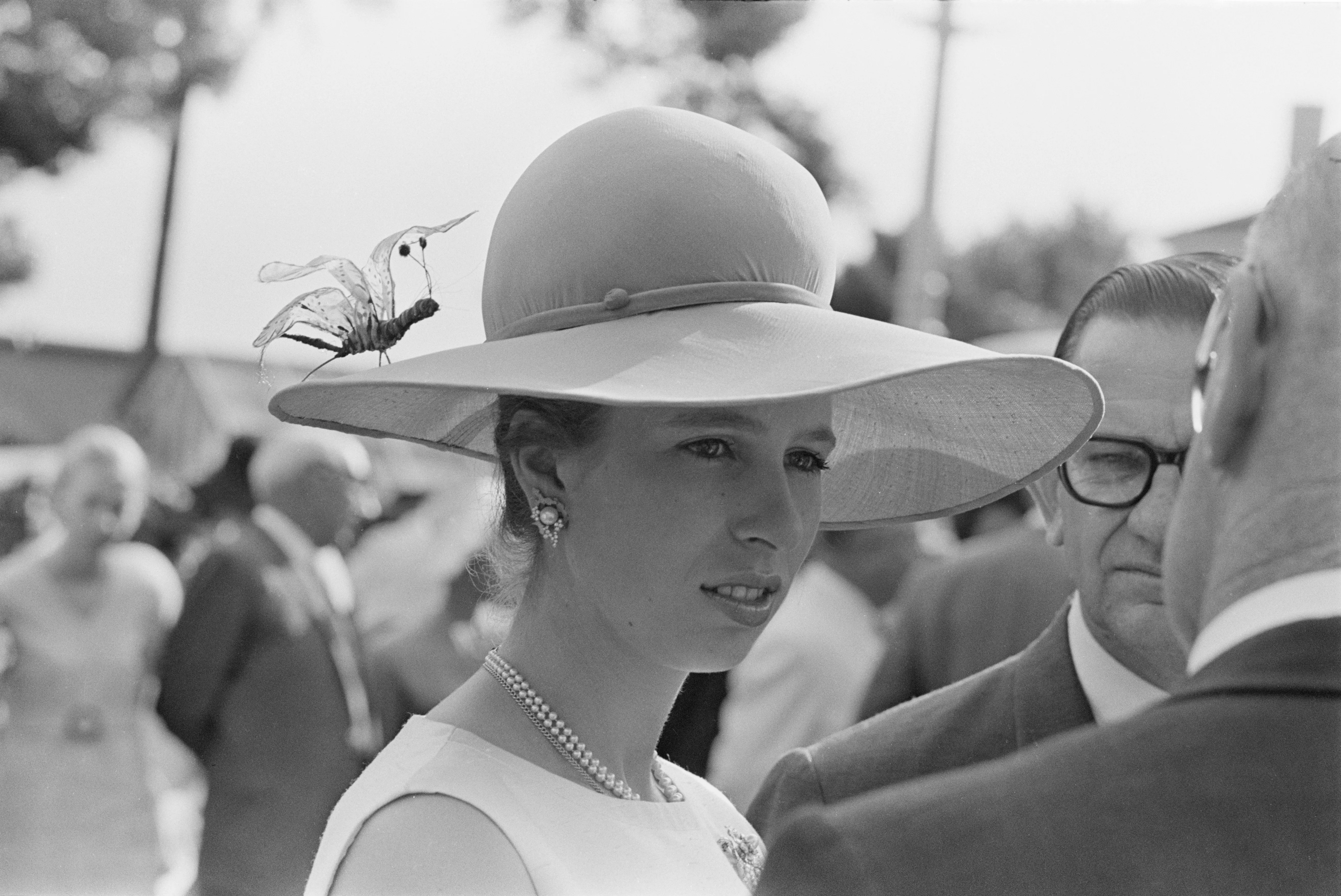 Princess Anne sports a wide-brimmed hat with an artificial insect on it, at a fashion show in Brisbane, Australia, April 1970.  (Photo by William Lovelace/Daily Express/Getty Images)