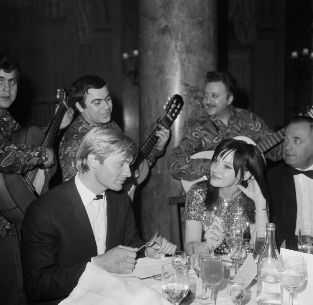 Oleg Vidov and friend sitting at a table. 