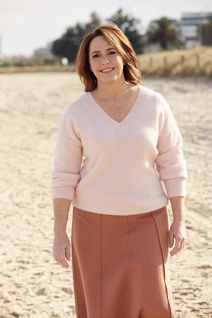 Lisa Millar walking on the beach. Photo by Sam Bisso