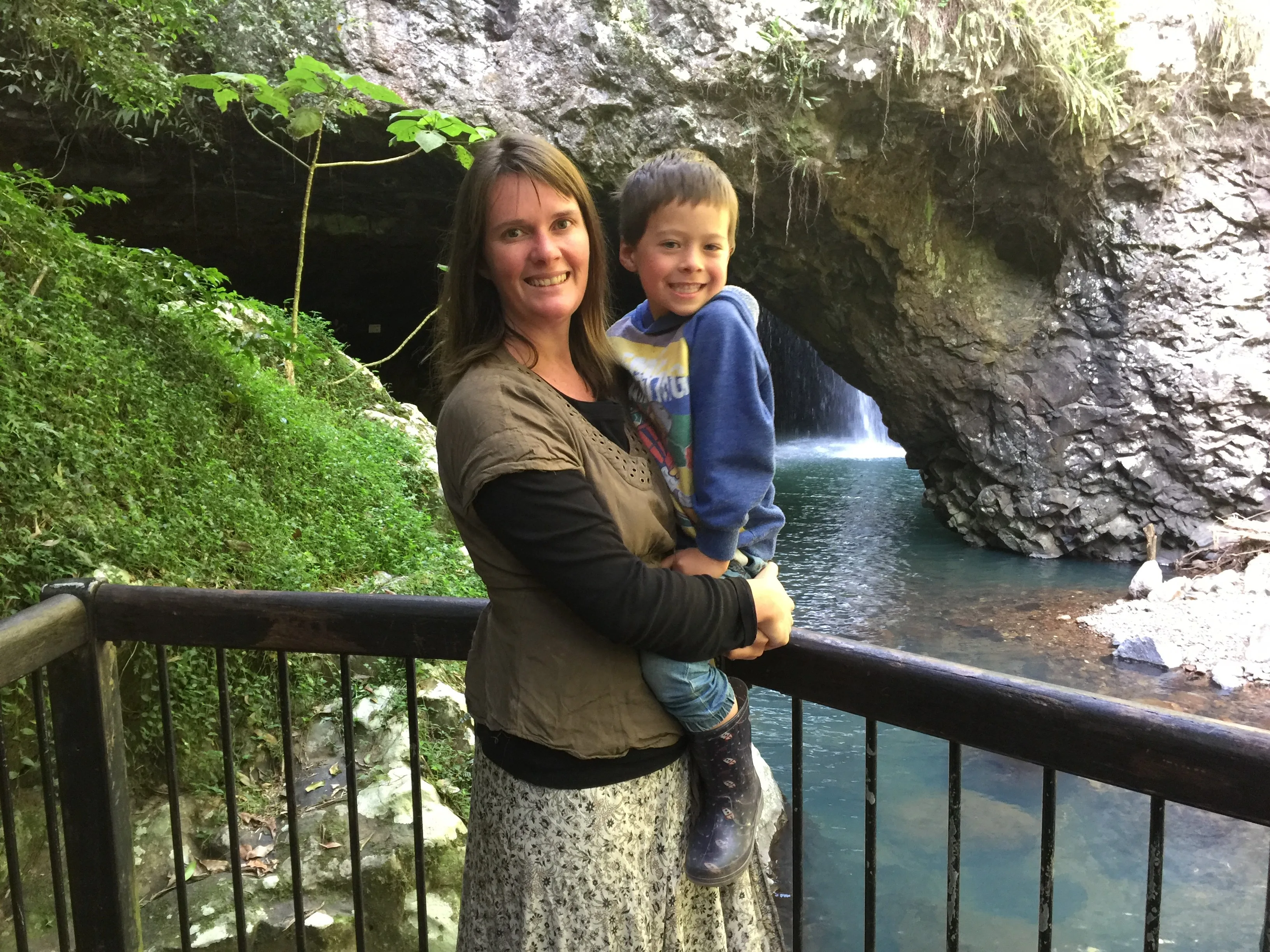 Lizz with son Rowan in front of a waterfall