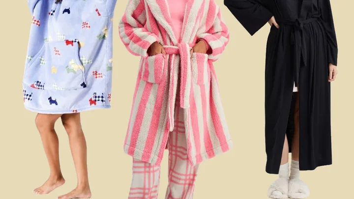 Three women wear different robes: a blue robe with dogs, a pink striped robe, and a black robe with white slippers.