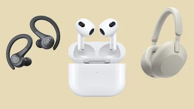 Three types of headphones: black earhooks, white earbuds with case, and over-ear headphones on a beige background.