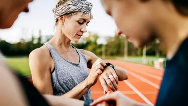 Women wearing fitness trackers, watches and rings.