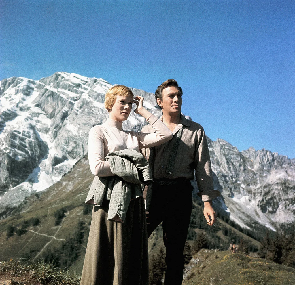 Photo of Julie Andrews and Christopher Plummer in front of a snow-capped mountain.