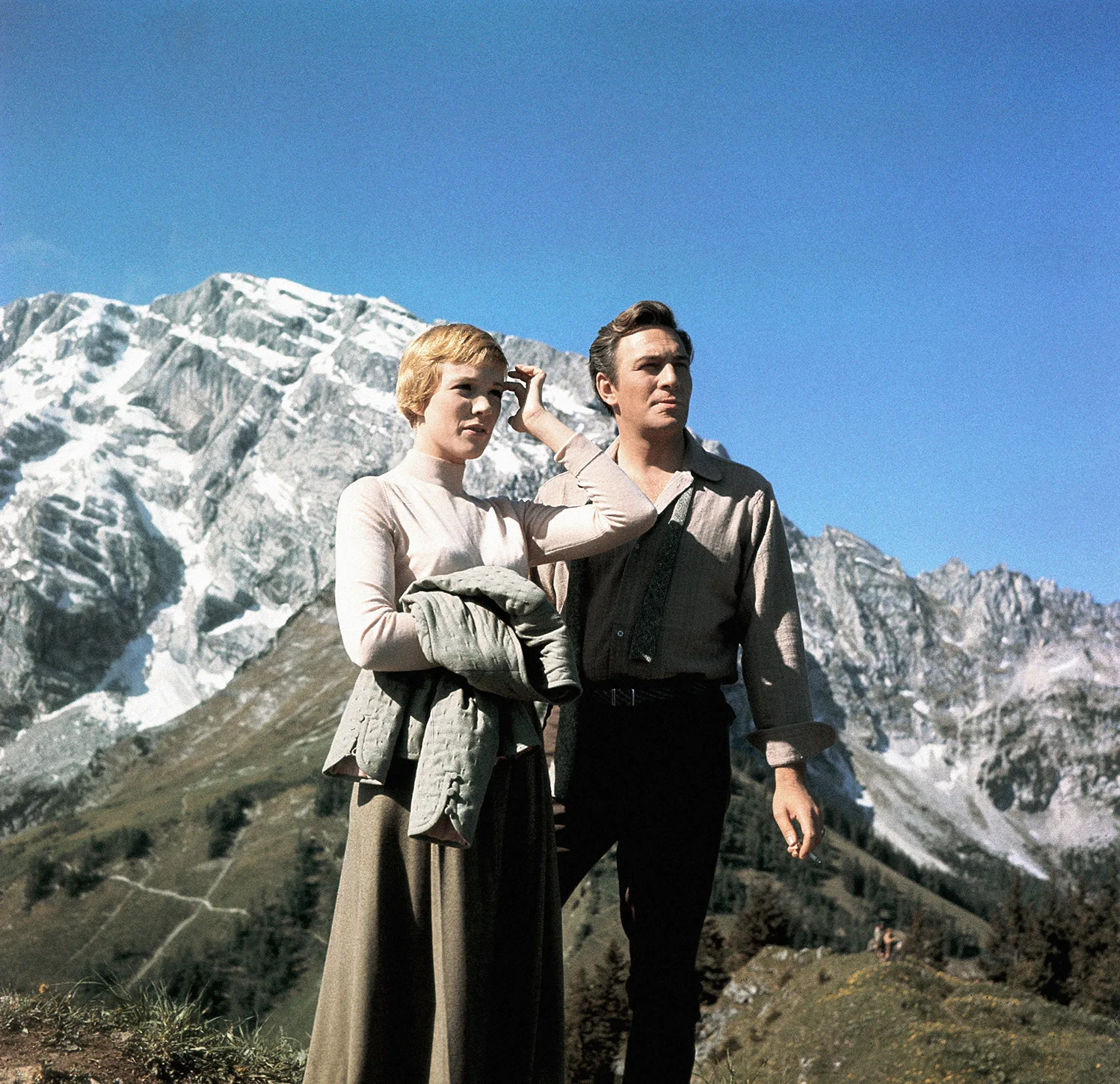 Photo of Julie Andrews and Christopher Plummer in front of a snow-capped mountain.