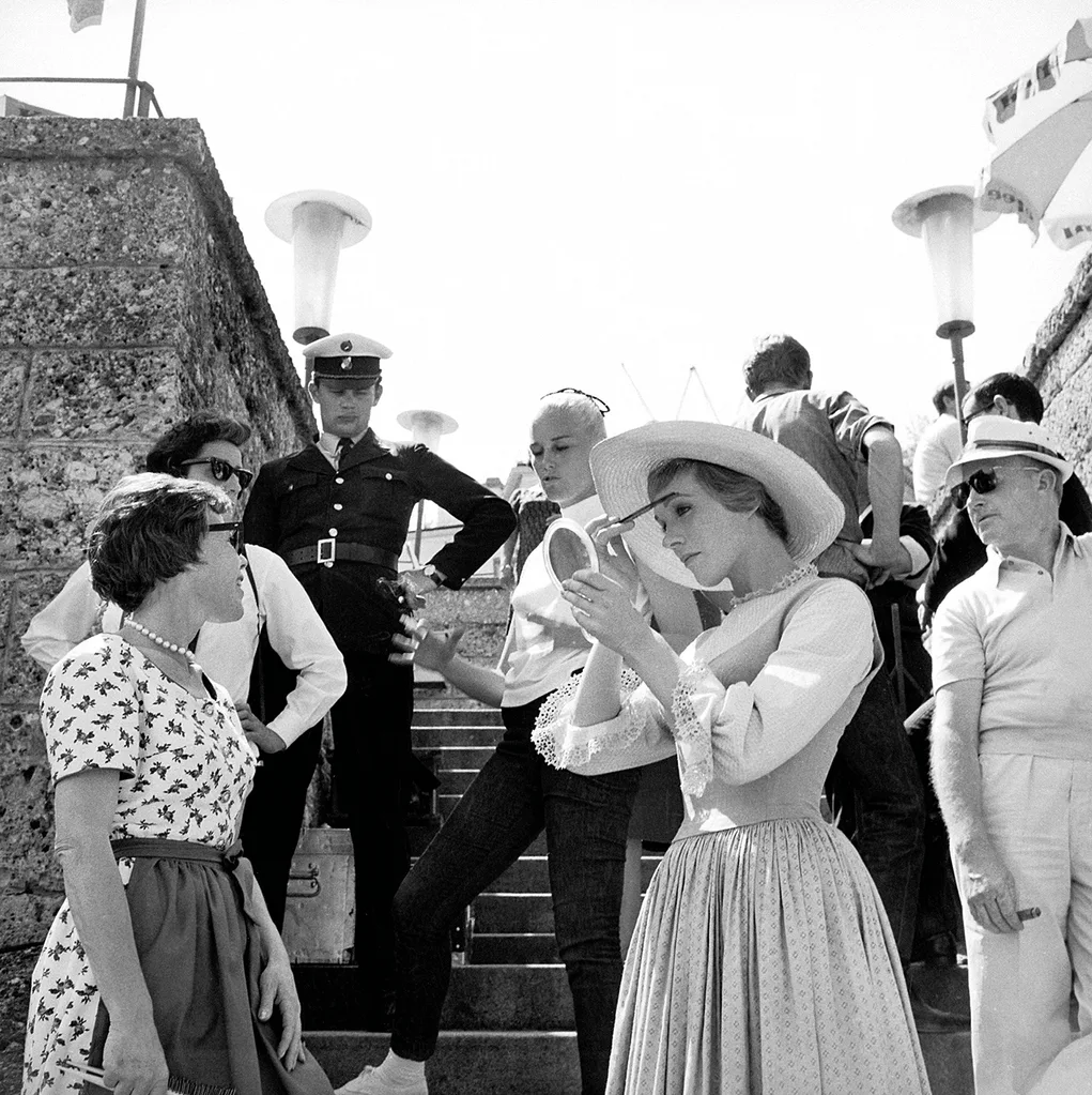 Julie Andrews adjusts her makeup on the set of The Sound of Music.