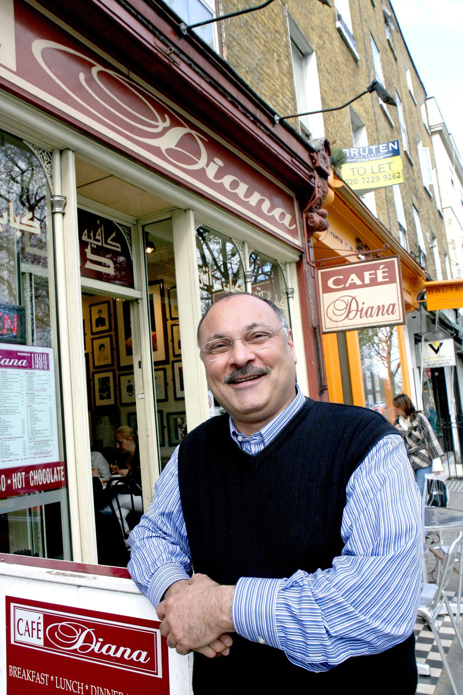 Abdul Daoud, founder of Cafe Diana, poses outside his cafe