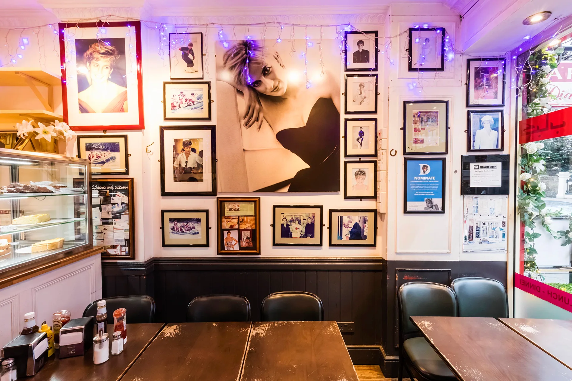 Interior of a cafe with framed photos of Princess Diana on the walls