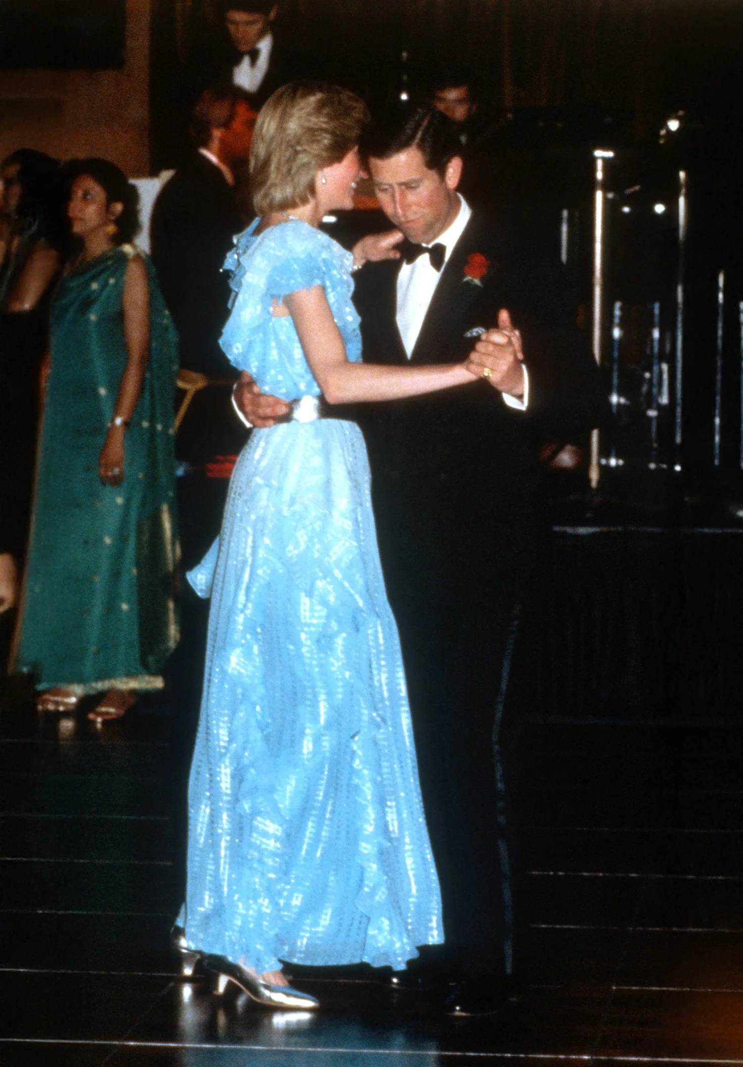 rince Charles, Prince of Wales and Diana, Princess of Wales, wearing a pale blue dress with a silver waist belt designed by Bruce Oldfield, dance together.