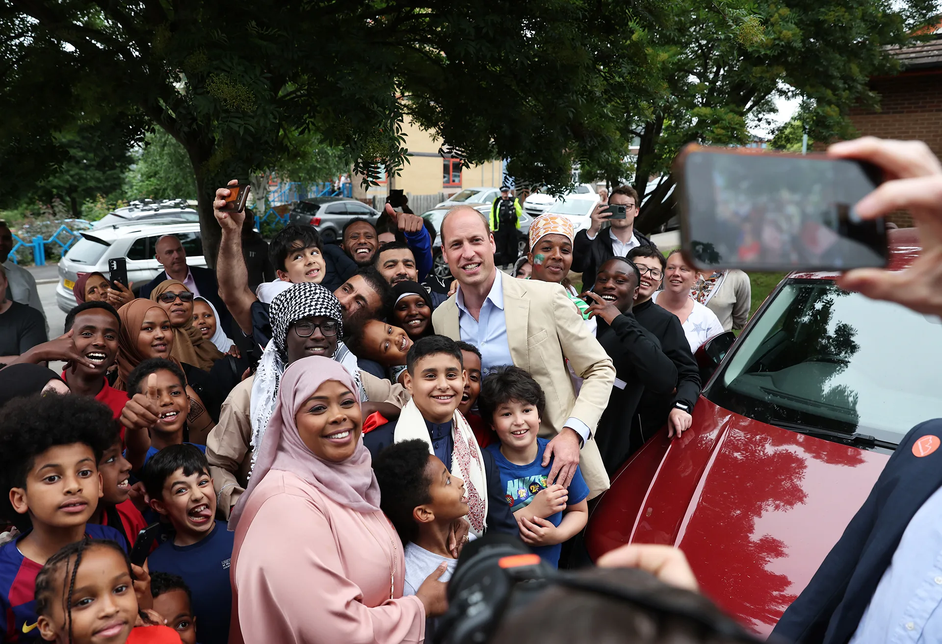 Prince of Wales poses for a photo with members of the public