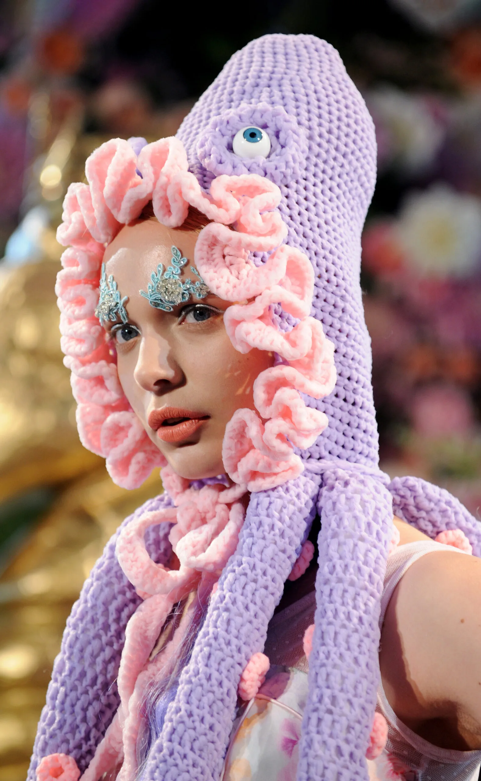 Fashion model wears a knitted octopus headpiece at Australian Fashion Week