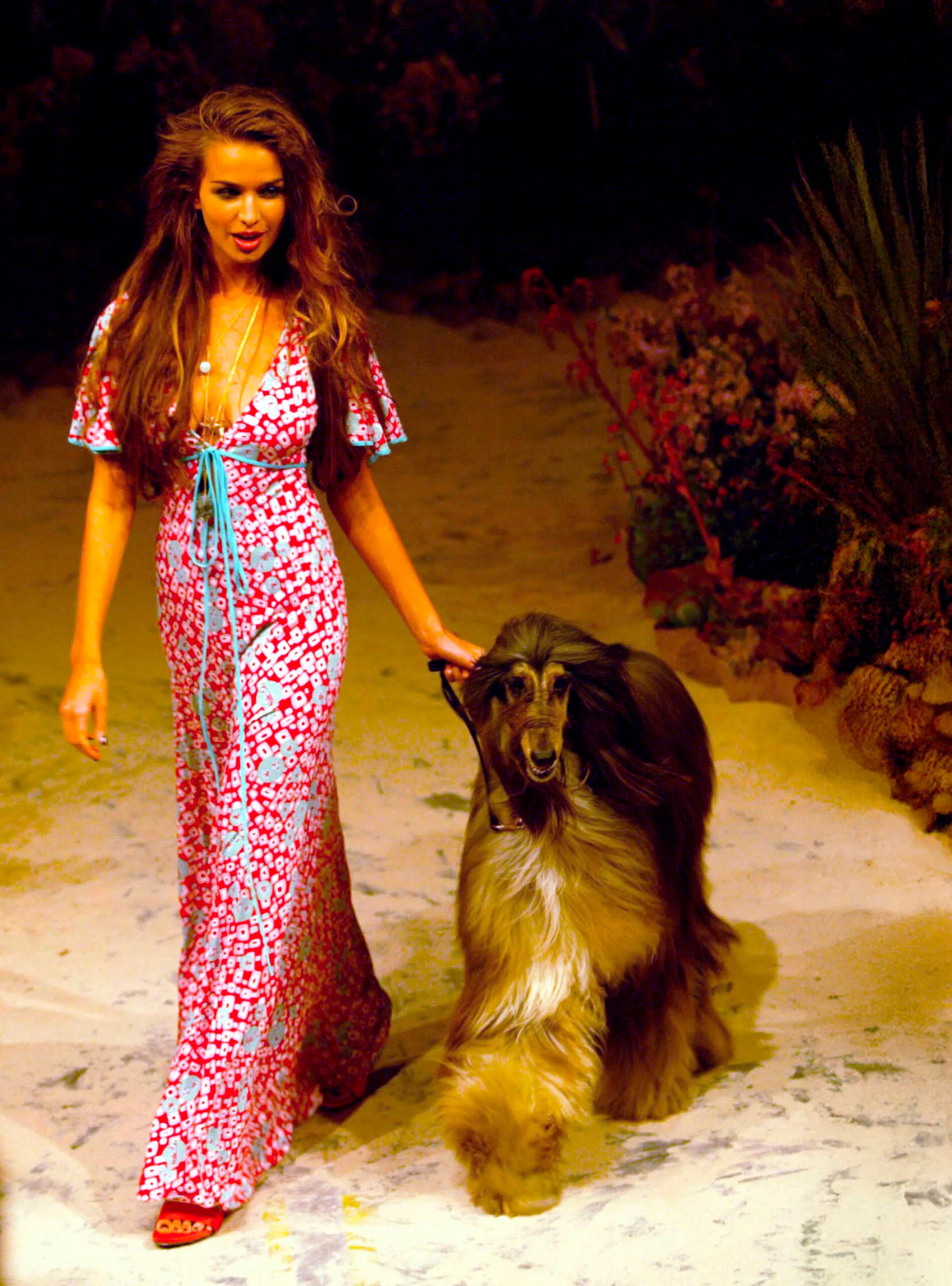 Fashion model leads a dog on the catwalk