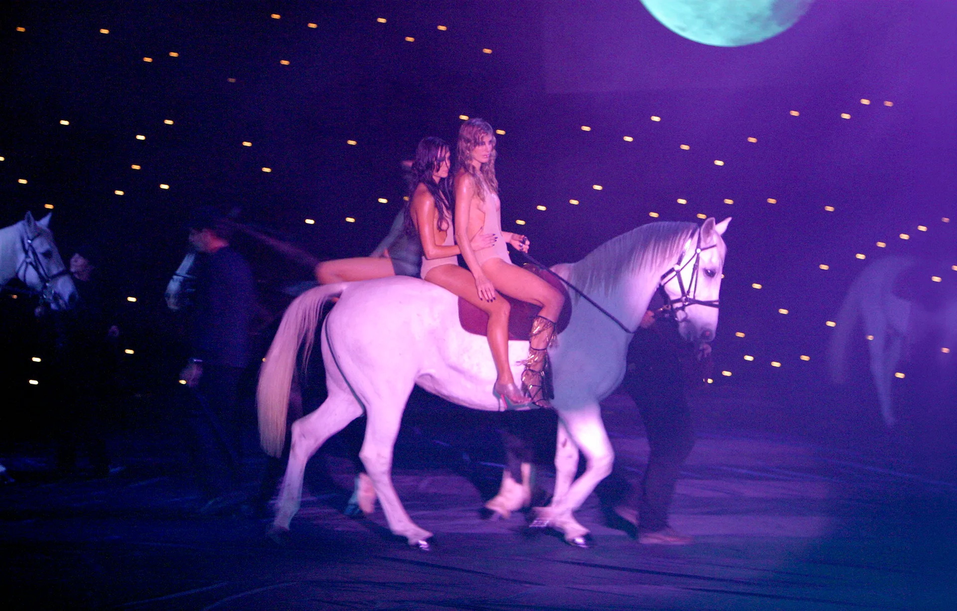 Two women on a white horse