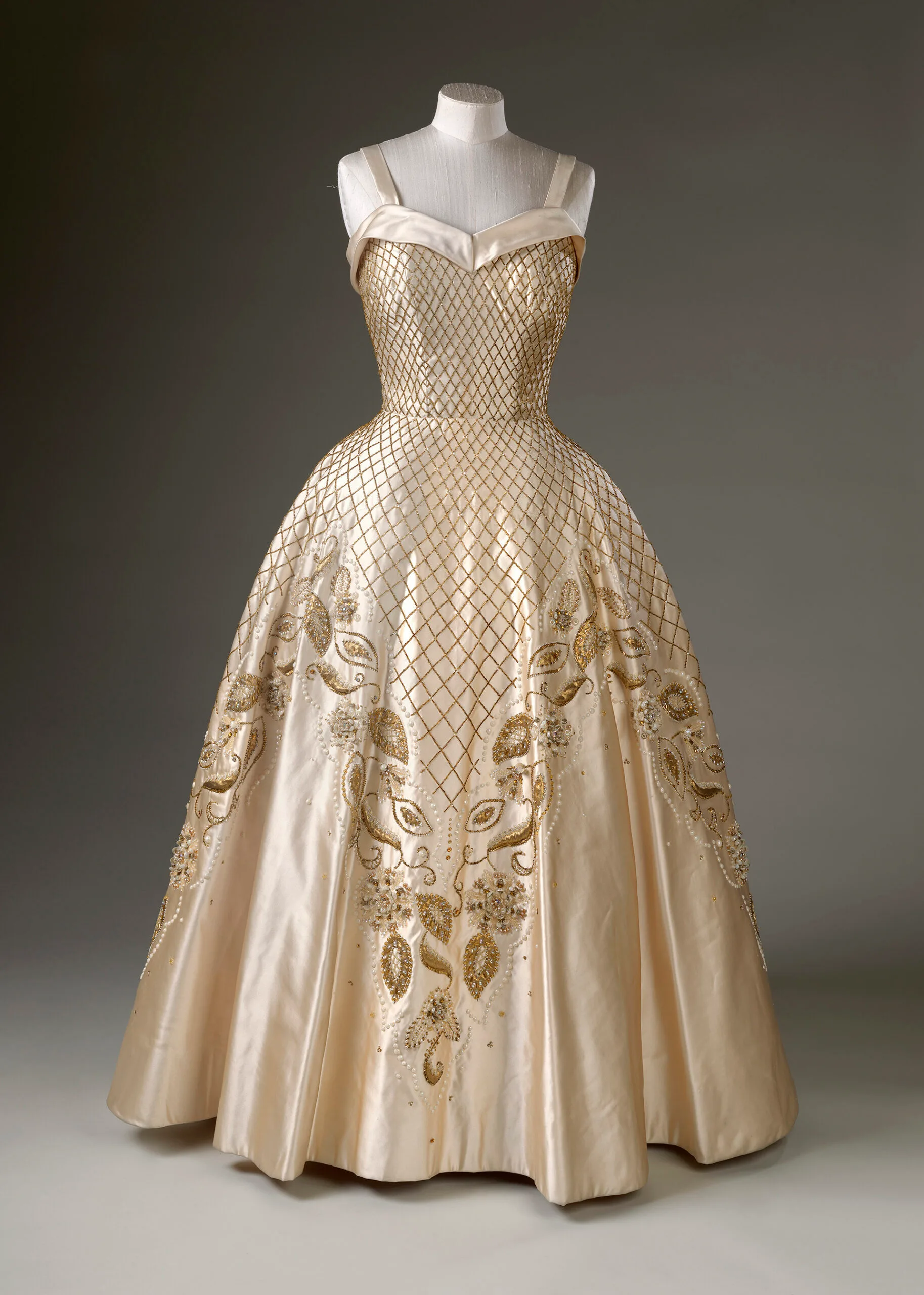 Gold evening gown by Norman Hartnell on a mannequin
