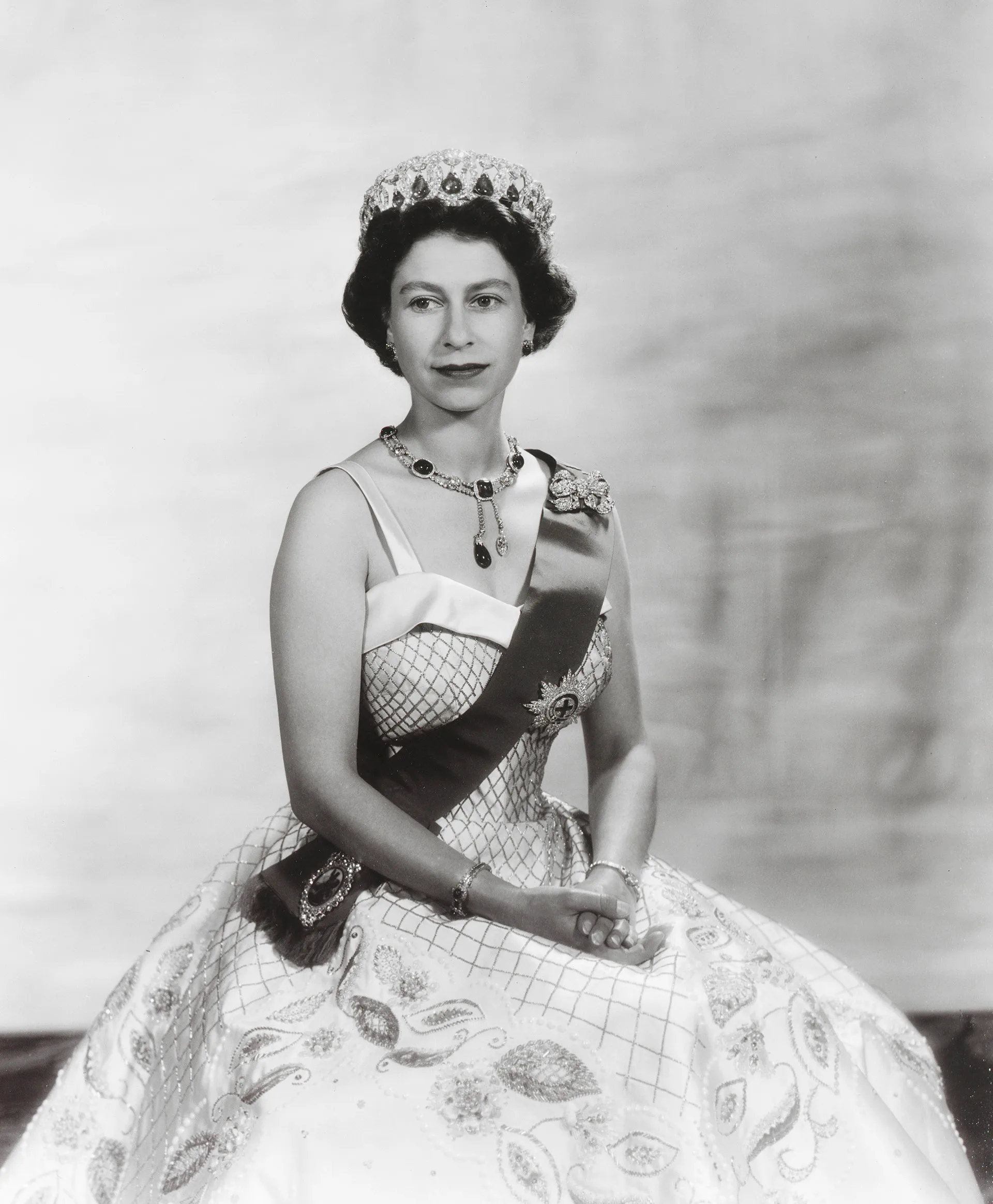 black and white photo of Queen Elizabeth II wearing a gown, sash and tiara