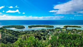 small islands in a lagoon and the ocean beneath a blue sky