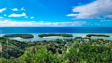 small islands in a lagoon and the ocean beneath a blue sky