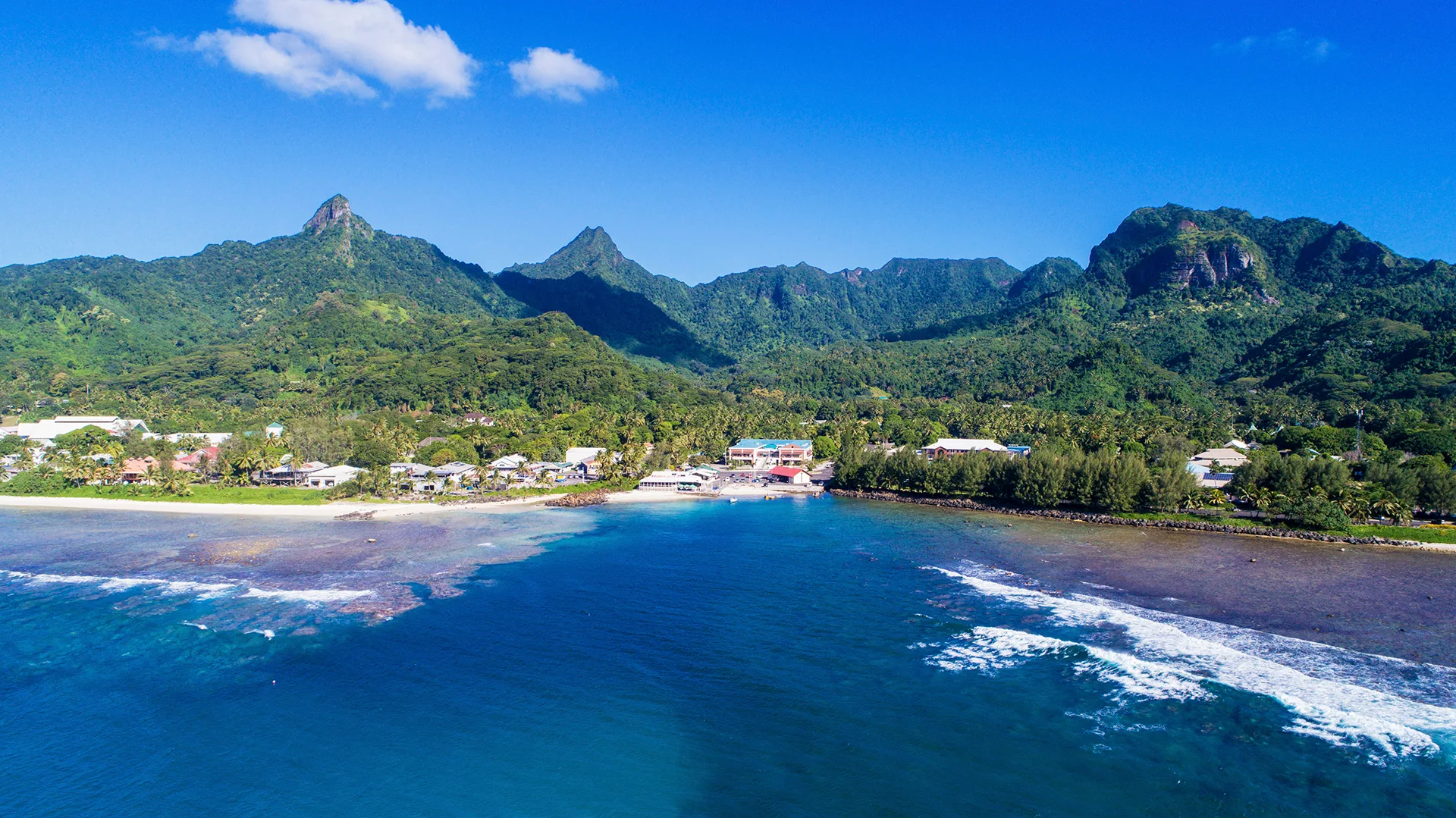 Coastline with green mountains in background