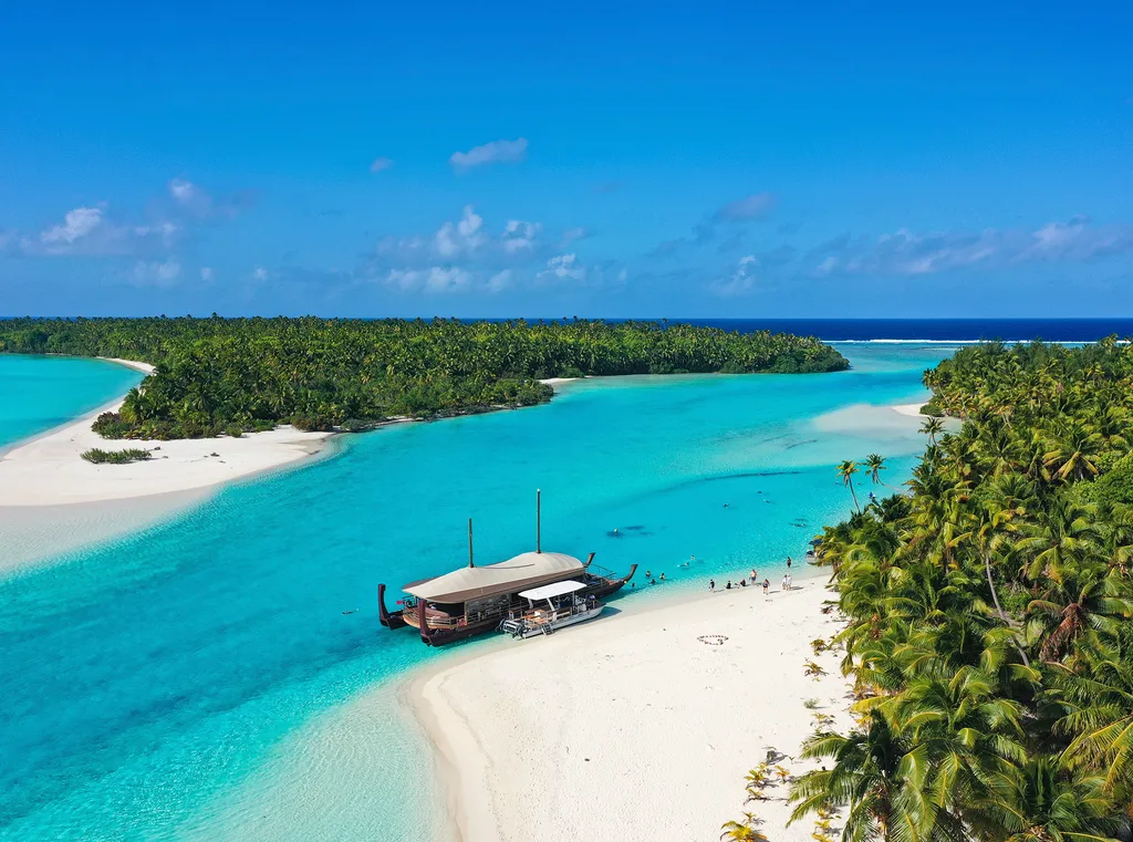 Blue lagoon and sandy bays with palm trees