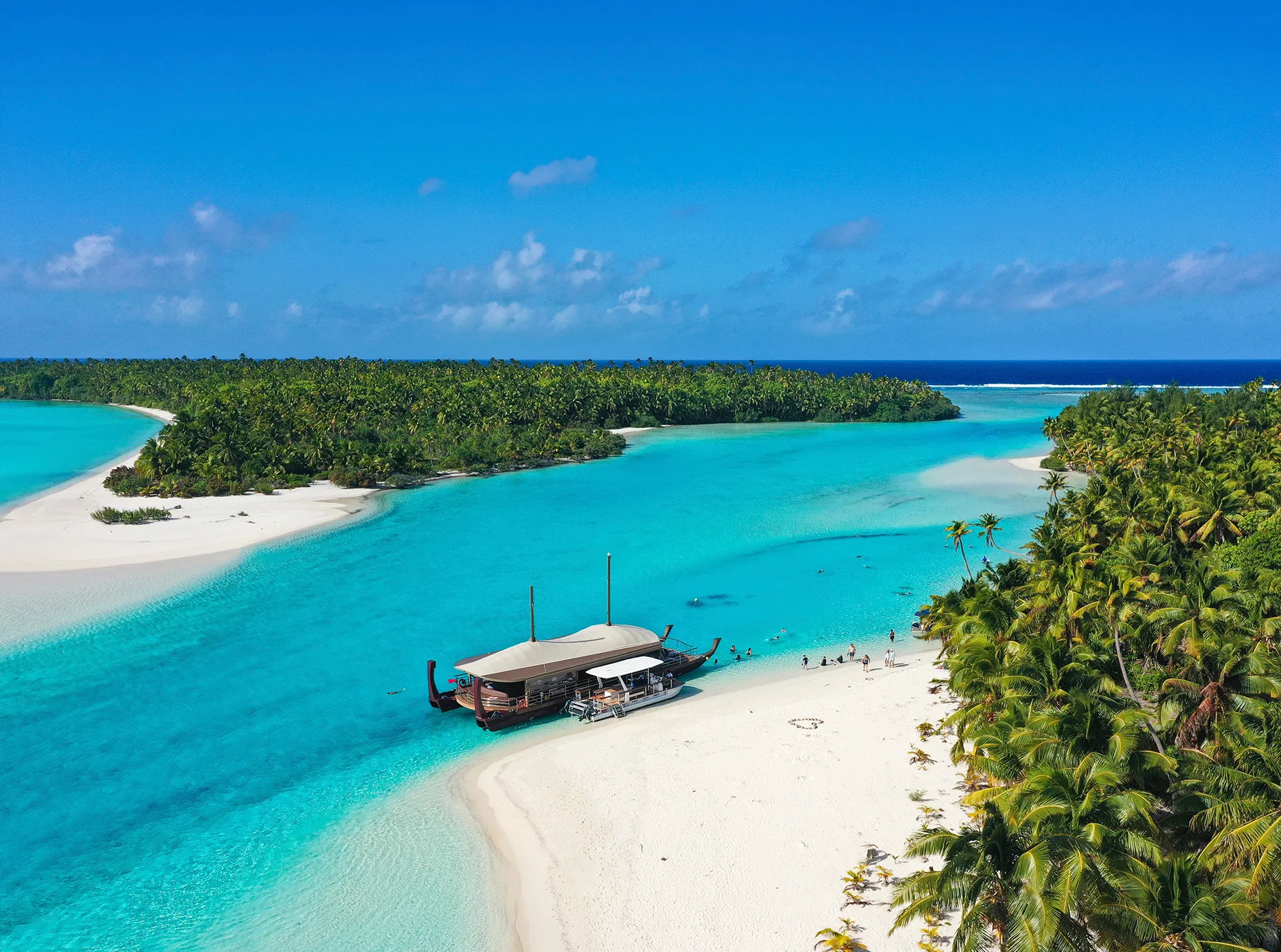 Blue lagoon and sandy bays with palm trees