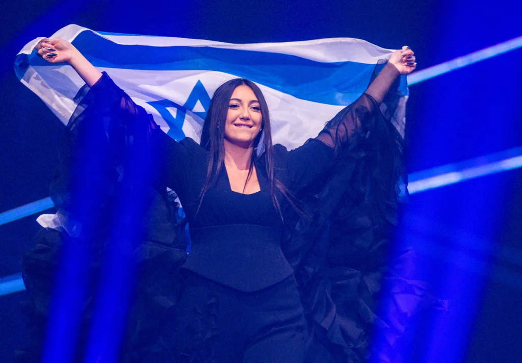 woman holds an israel flag at eurovision song contest 2025