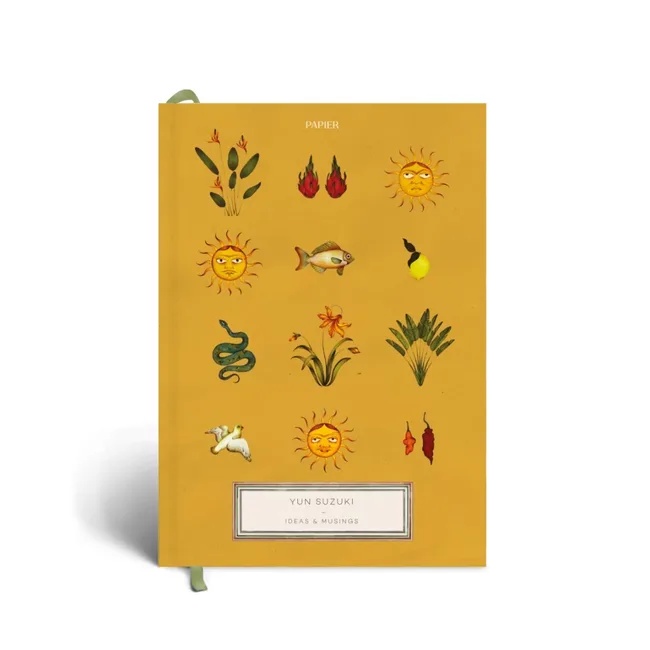 Yellow notebook cover with sun, plants, and animal illustrations. Text: "Yun Suzuki Ideas & Musings."