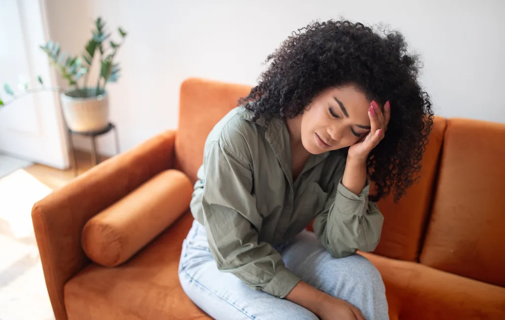 Woman suffering with migraine headache.