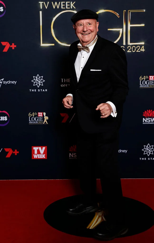 Man in a black tuxedo and bow tie smiles on the red carpet at the TV Week Logie Awards 2024.