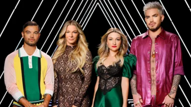 Four people stand in front of a geometric black and white background, wearing colorful and stylish outfits.