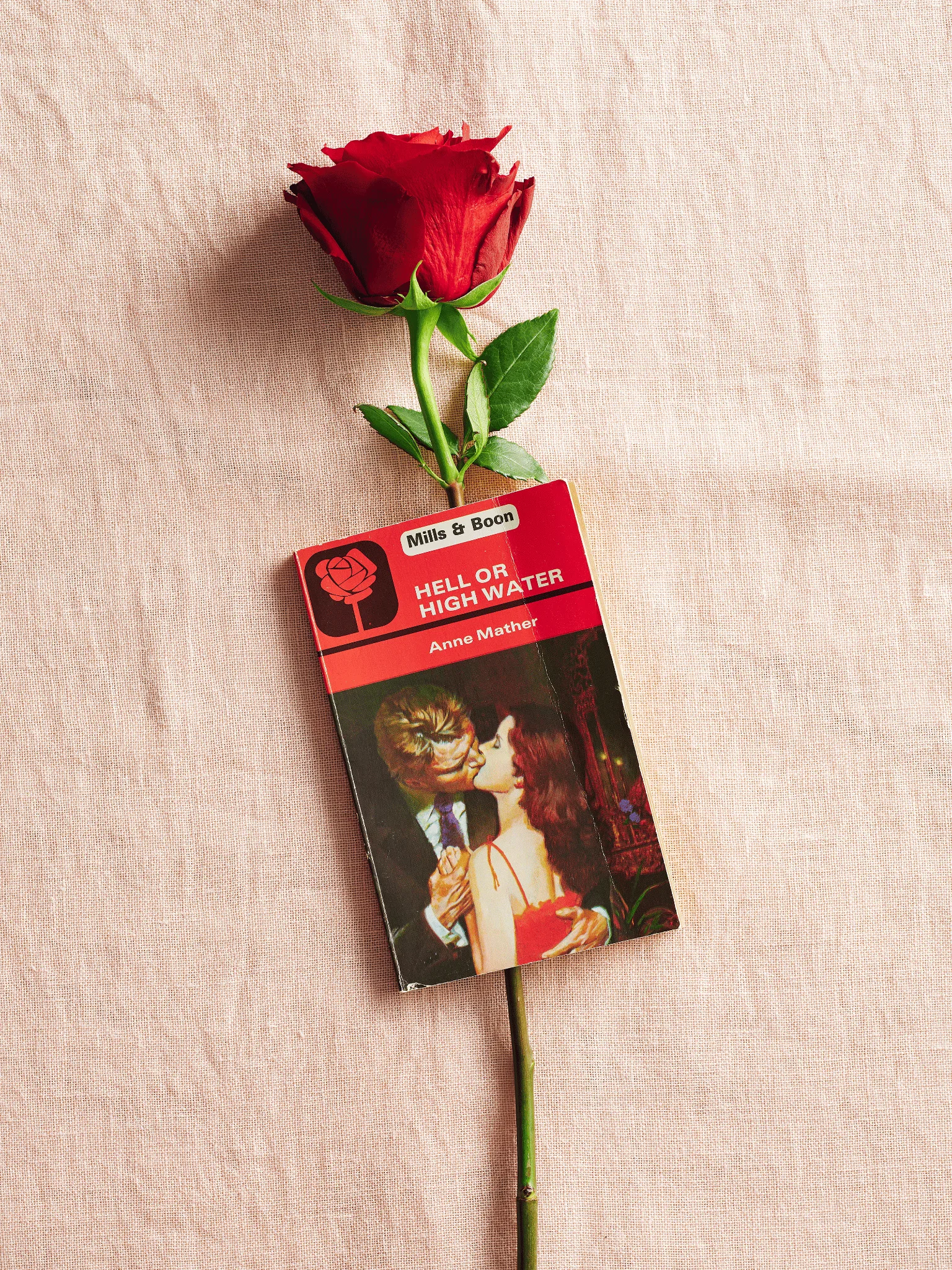 Mills & Boon book Hell or High Water with a rose