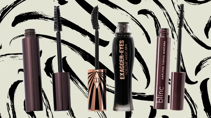 Four tubes of mascara with black and brown packaging against a black and white abstract background.