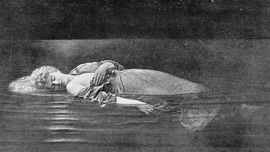 A woman in a dress floats serenely on water, eyes closed, seemingly asleep.