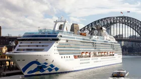 Cruise ship Coral Princess docked in Sydney with the Harbour Bridge in the background.