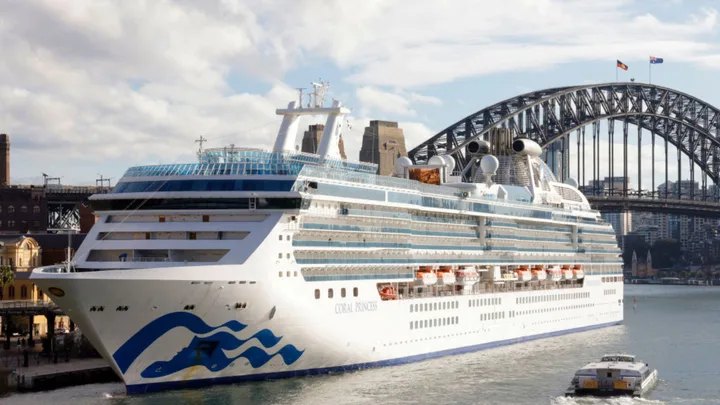 Cruise ship Coral Princess docked in Sydney with the Harbour Bridge in the background.