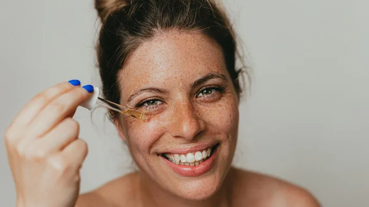 Lady applying skincare to her face