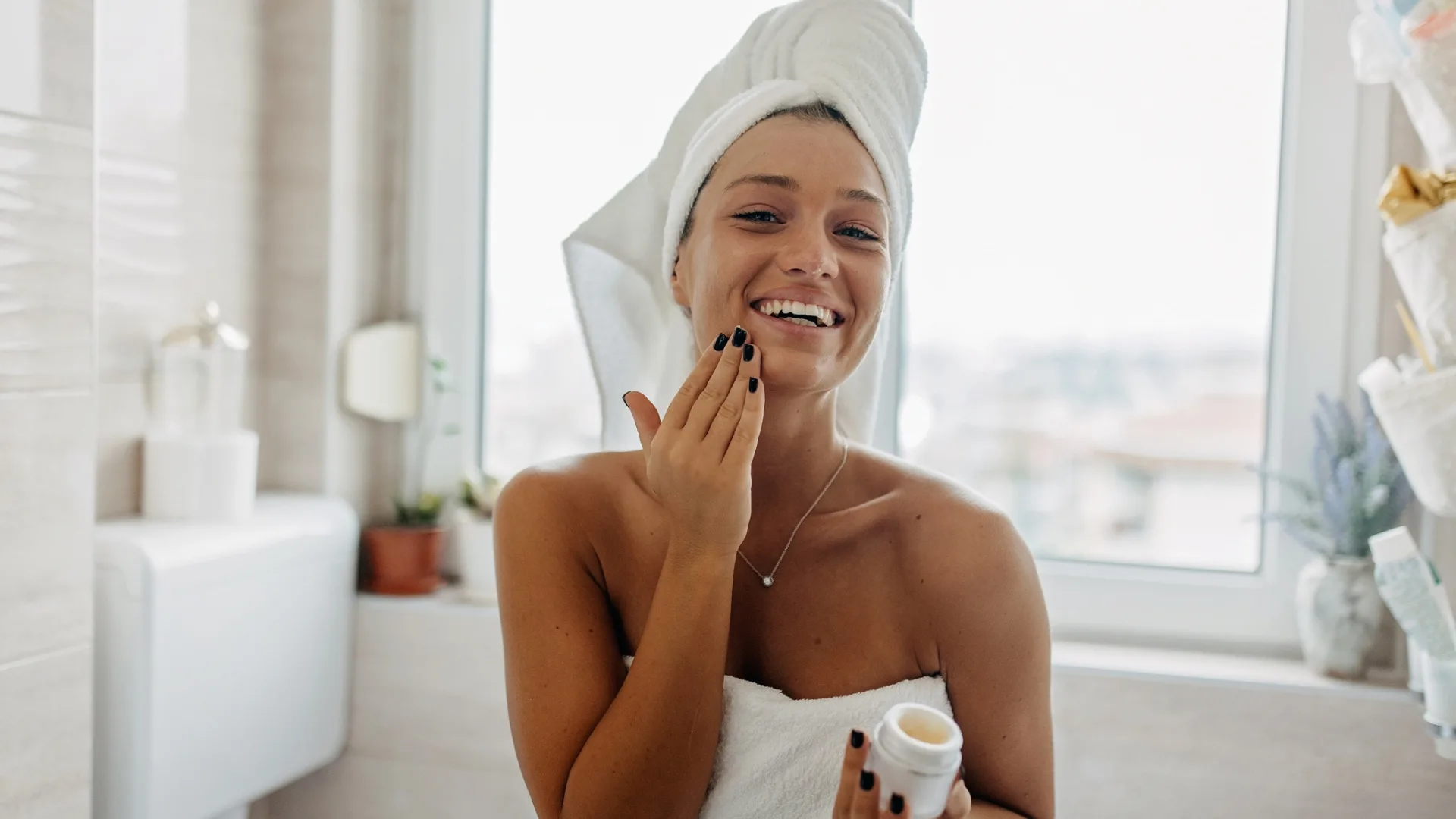 Woman in bathroom doing skincare