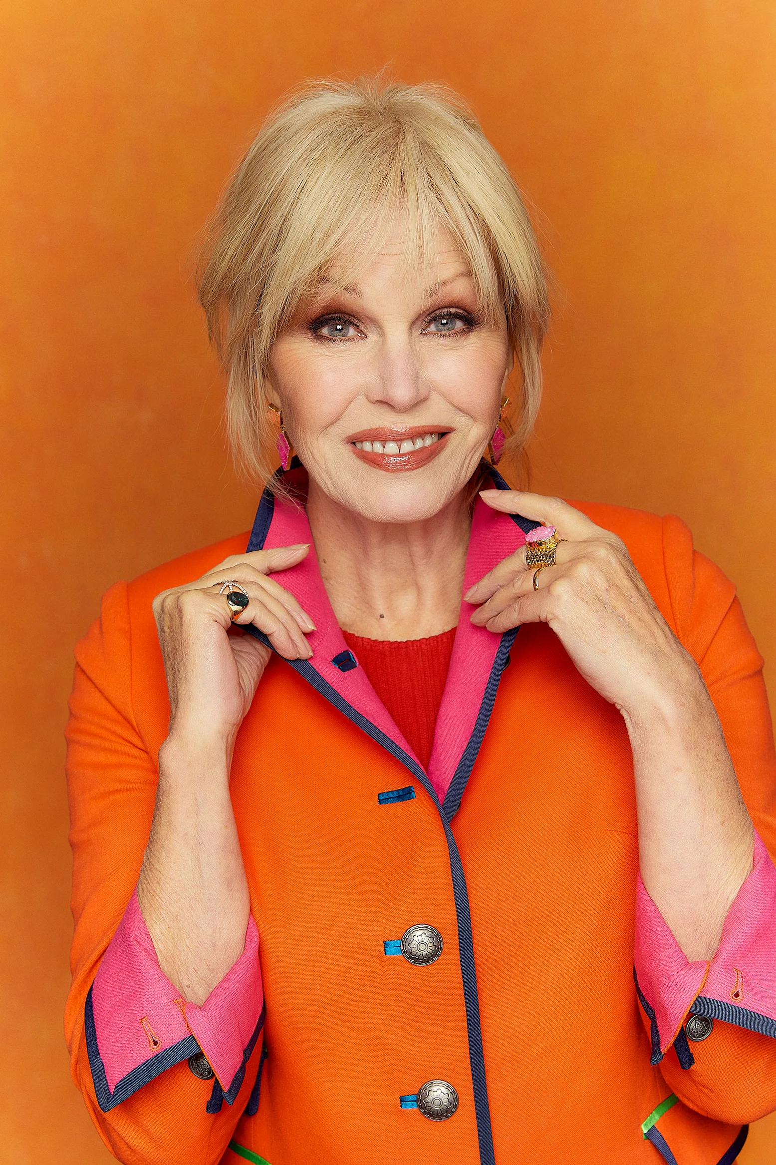Joanna Lumley in an orange jacket. 