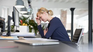 Stressed woman at work desk