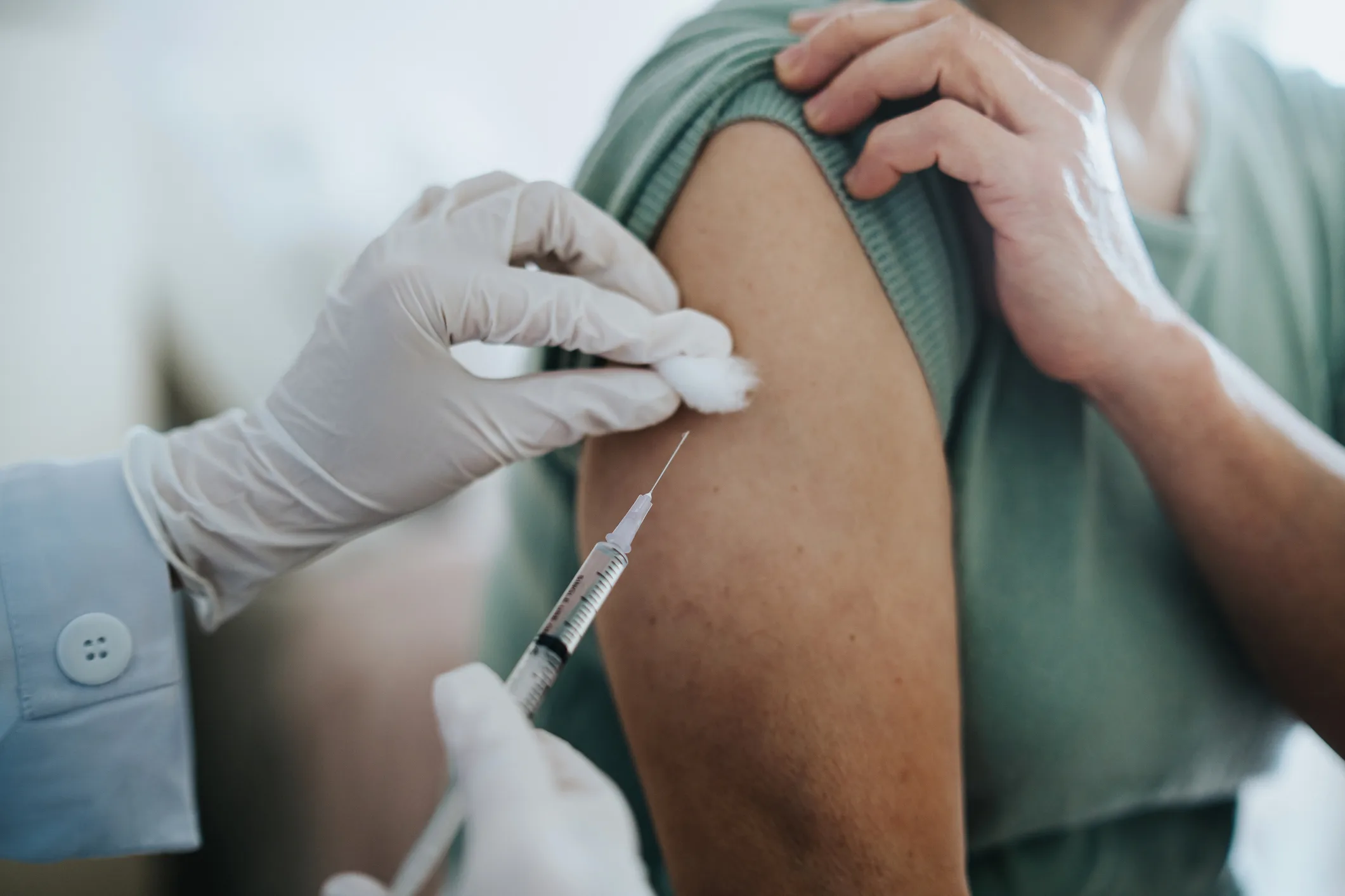 Woman getting needle vaccination