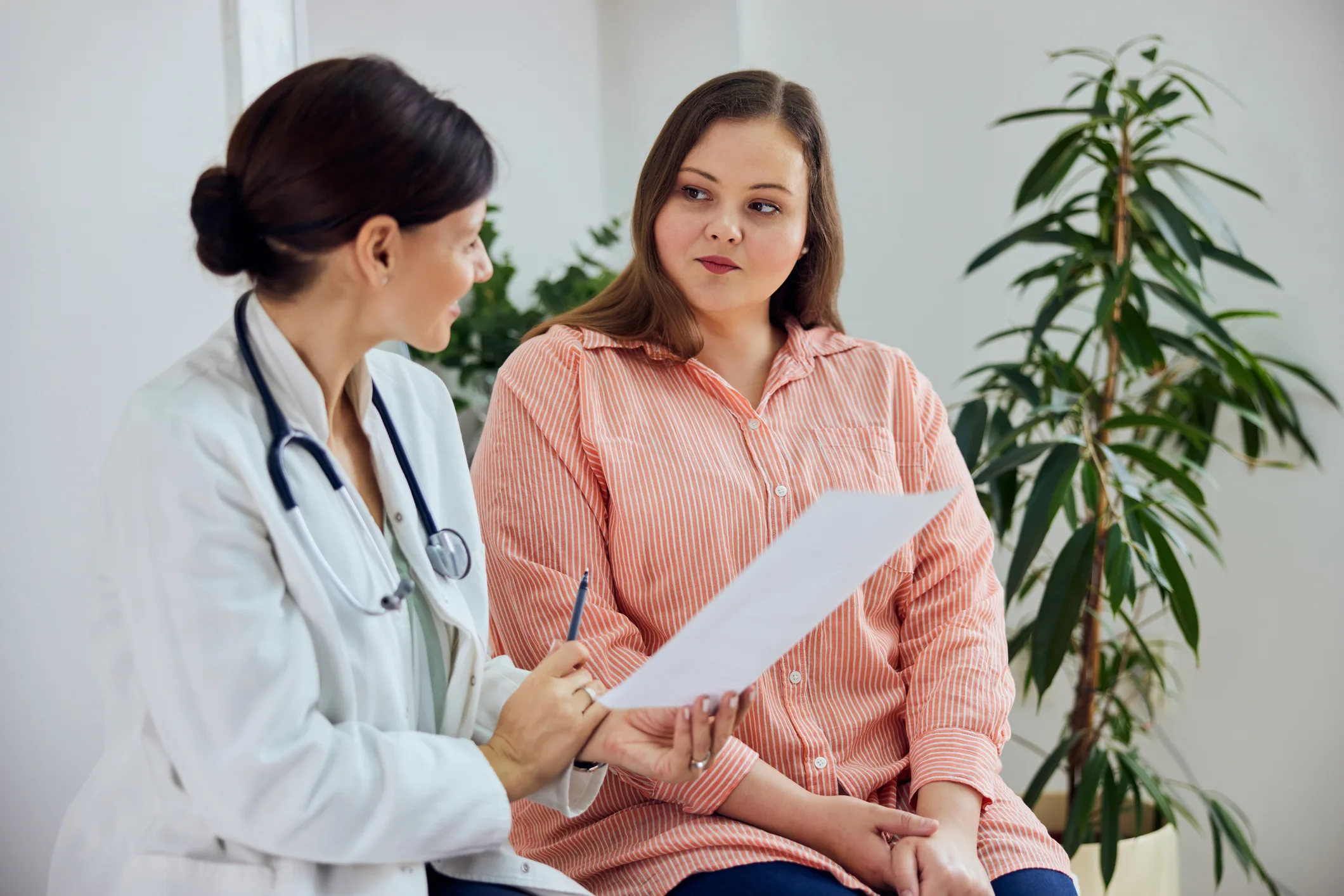 Female patient talking to GP doctor