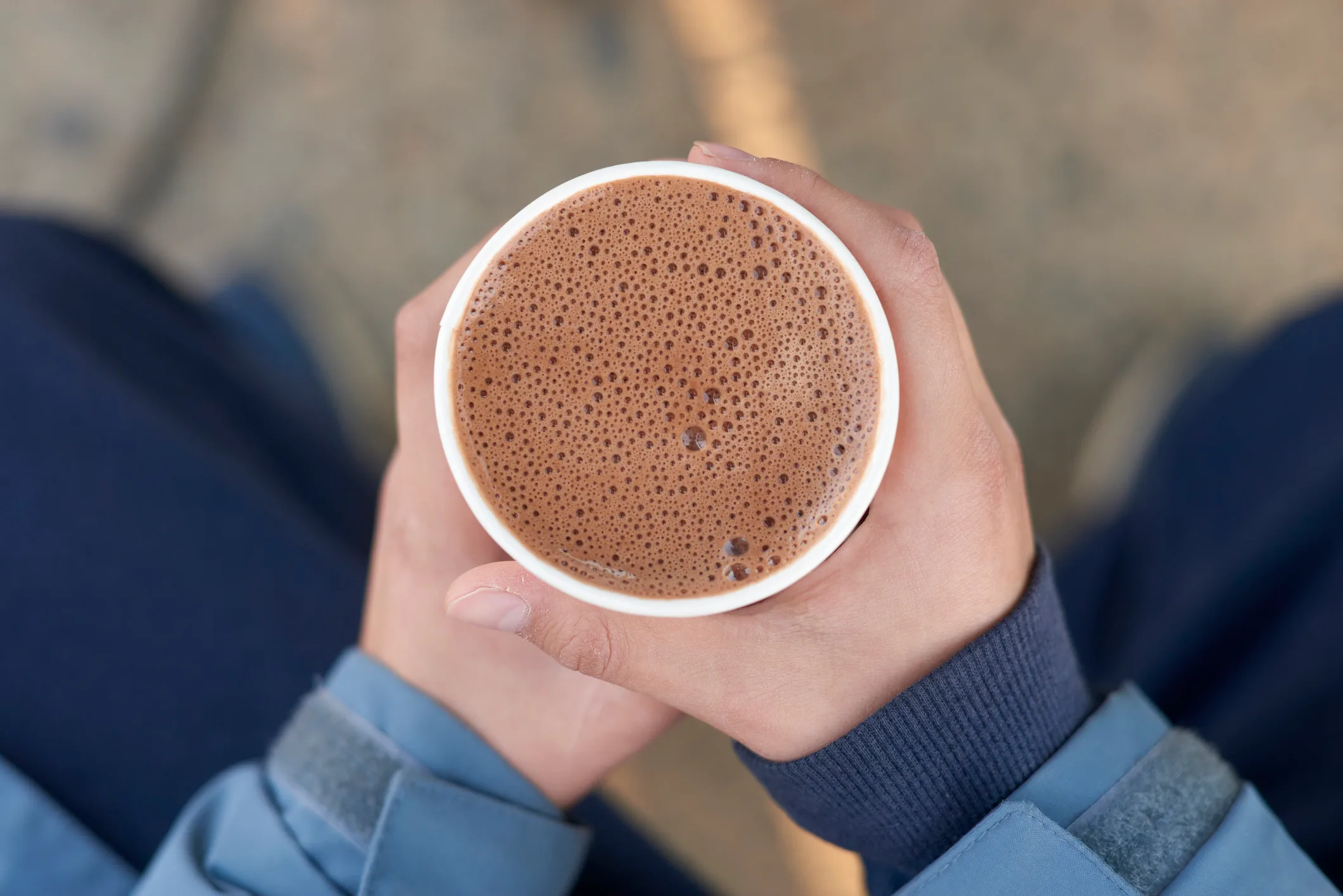 Person holding hot cup of cacao