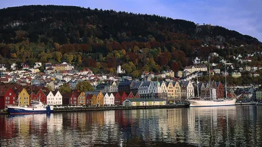Bergen in Norway seen from the water. Colourful buildings at the foot of a mountain.
