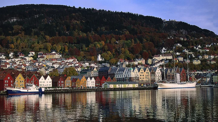 Bergen in Norway seen from the water. Colourful buildings at the foot of a mountain.