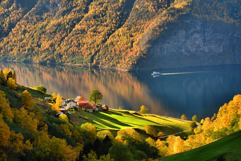 A ship cruises on a fjord in Norway